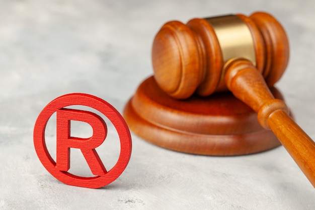 Judge gavel and red trademark sign.