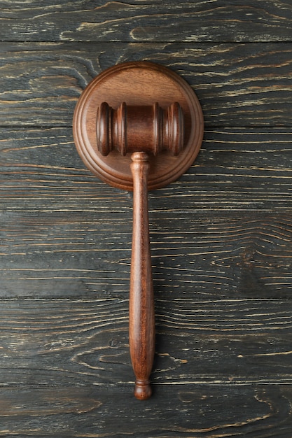 Photo judge gavel on rustic wooden background, top view