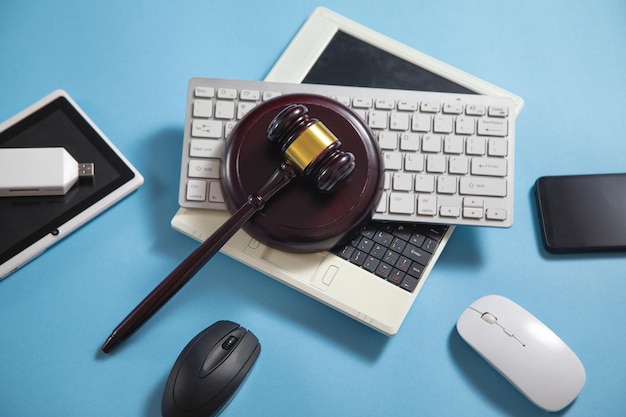 Judge gavel with a computer keyboard tablet