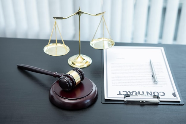 Judge gavel with Justice at law firm in background with legal case document contract, law and justice, attorney, lawsuit.