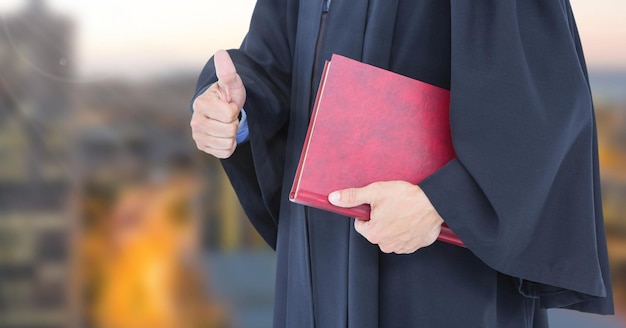 Judge holding book in front of city