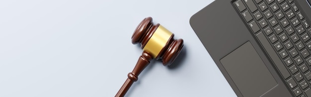 Judge's Gavel and Laptop Computer on Gray Background with Copy Space