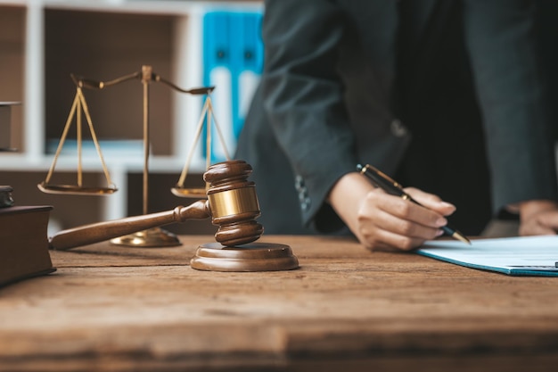 The judge's hammer is placed on the table the lawyer concept assumes that the defendant defends the client in order to win the case or gain the greatest benefit in accordance with the law