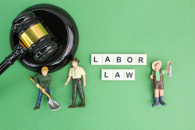 Photo judge's hammer and labor workers with the word labor law labour law concept