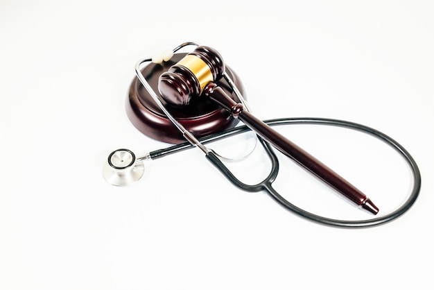 Judge's mallet next to stethoscope on a white