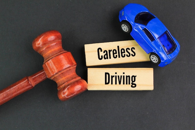 judges gavel car and stick with the word careless driving driving without reasonable consideratio