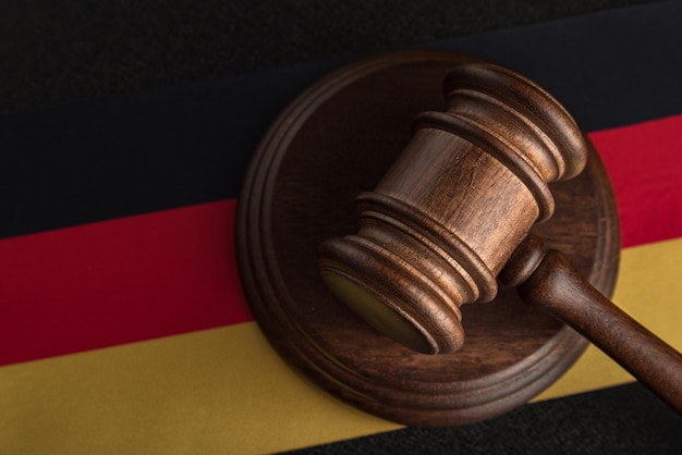 Judges hammer and flag of Germany Law of Germany Violation of rights