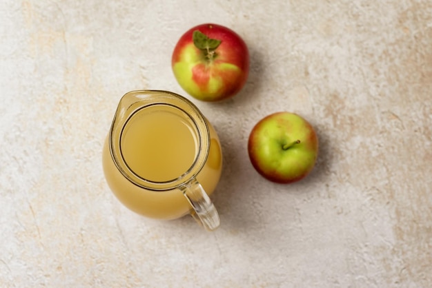 Jug of Apple Juice with Pulp on Concrete Background Raw Red Appe Rustic Top View