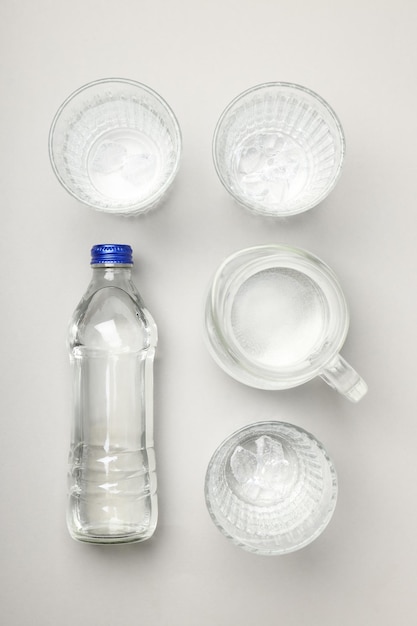 Jug bottle and glasses of water top view