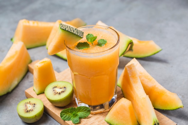 The juice of melon with mint in a glass jar on the table.Hami melon