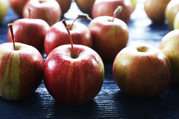 Juicy apples on wooden table closeup