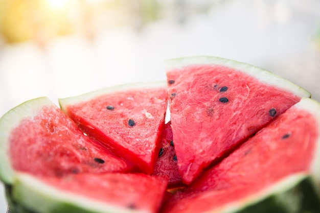 Juicy bright red pieces of sliced watermelon on a black table background