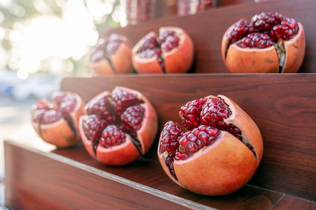 Juicy fruits of ripe pomegranate without peel, berries Shine in the sun. Street trading in Thailand