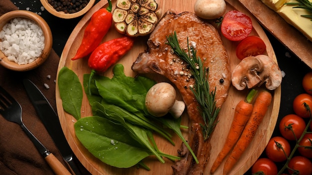 Juicy grilled pork chop steak or tomahawk steak serve with healthy grilled vegetables top view