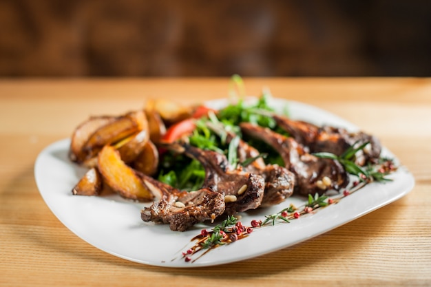 Juicy grilled ribs, cooked with vegetables and rosemary