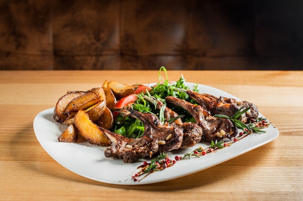 Juicy grilled ribs, cooked with vegetables and rosemary