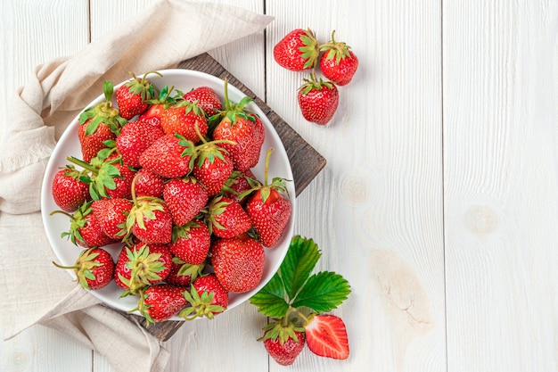 Juicy, healthy strawberries on a white background. Summer berries. Top view, copy space.