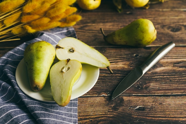 Juicy pear on plate on table