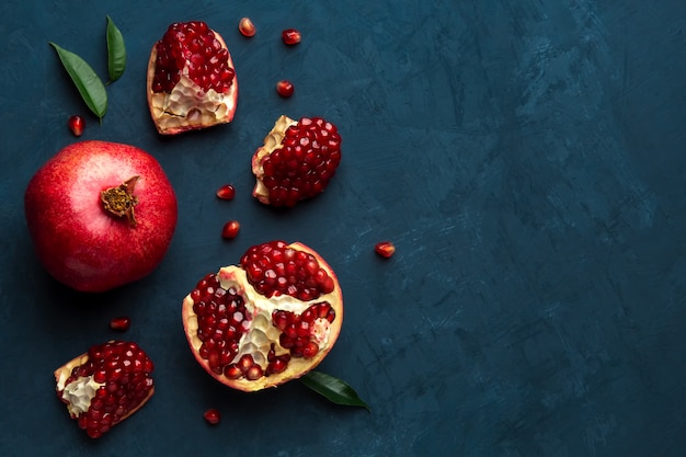 Juicy pomegranate on blue with place for text