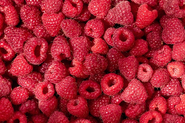 Juicy raspberries closeup Background from raspberriesTexture of raspberry macro photo Healthy organic food Raspberry harvest