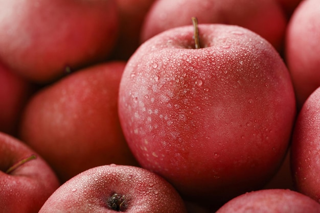 Juicy Red apple close-up with dew drops. Ripe fruit In full screen