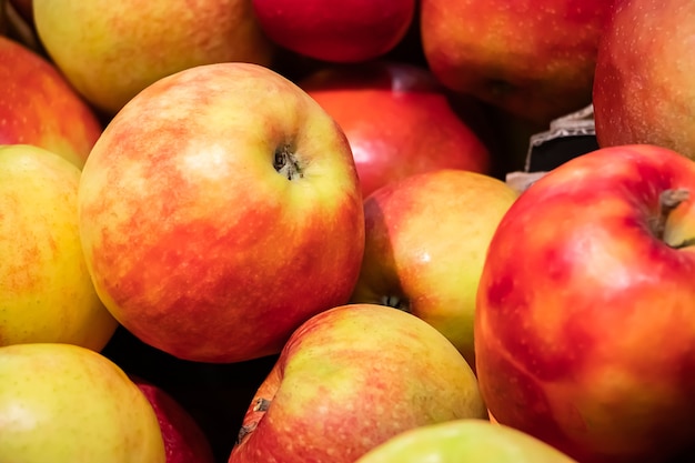 Juicy red apples at a farmers market. Ripe fruits close up.