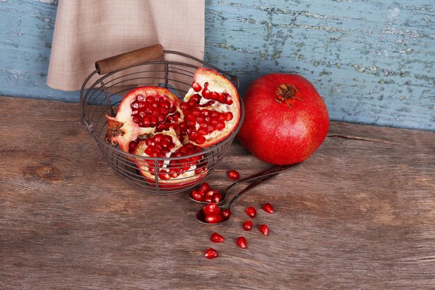 Juicy ripe pomegranates on old wooden table