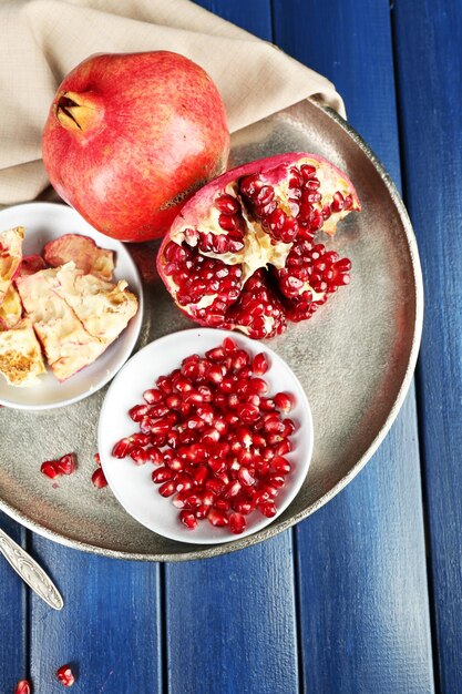 Juicy ripe pomegranates on wooden table