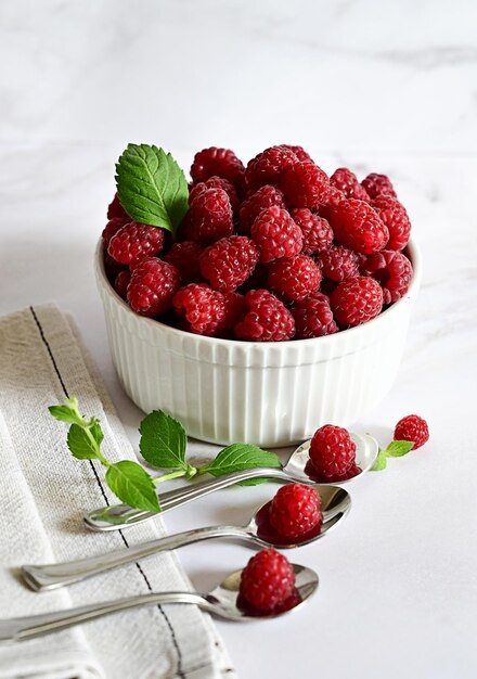 Juicy ripe raspberries in a plate on a white backgroundripe raspberries in a white plate on a white background vitamins for the body