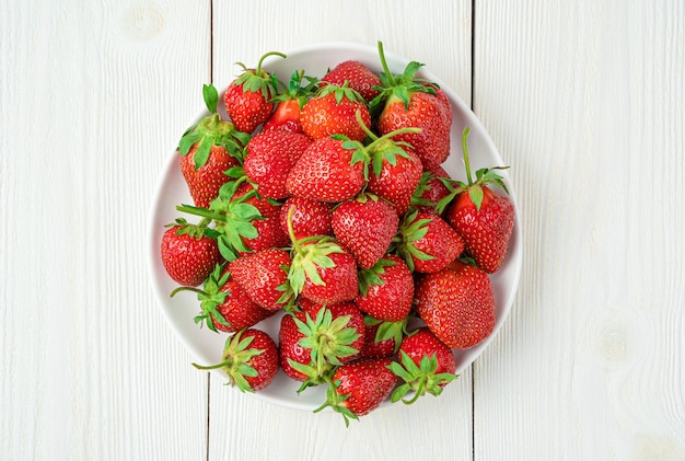 Juicy, ripe strawberries on a white background. Top view, close-up. Summer berries.