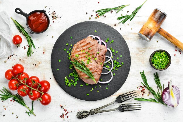 Juicy roasted veal steak with rosemary and spices Top view Free space for your text