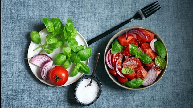 Juicy salad with tomatoes basil and blue onion