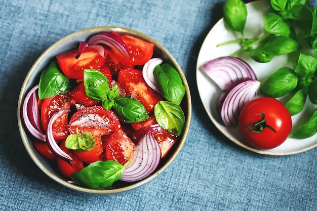 Juicy salad with tomatoes basil and blue onion