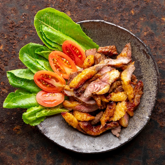 juicy sliced grill beef fillet steak meat in wabi sabi plate on rusty texture background top view flat lay square ratio