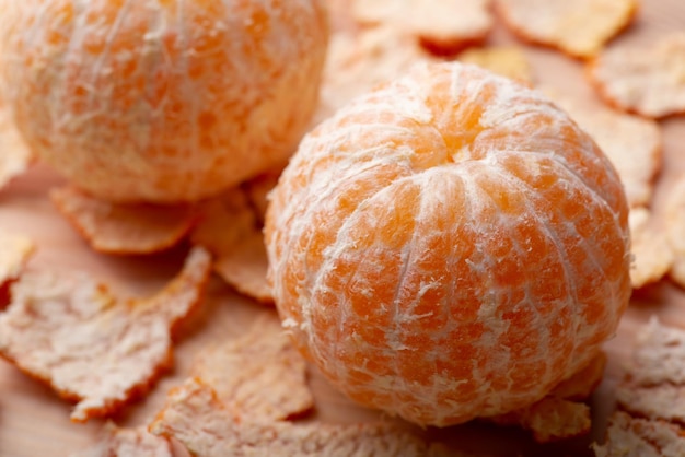 Juicy tangerines on wooden background Peeled off tangerines