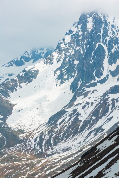 June view from the Karlesjoch Alps mountain (3108 m, near Kaunertal Gletscher on Austria-Italy border) over precipice and clouds