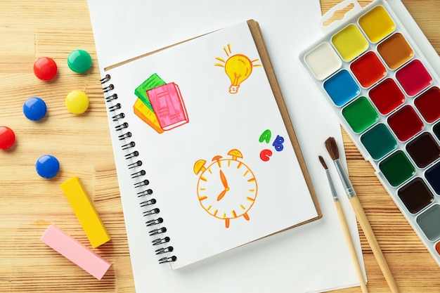 Junior school accessories on wooden background top view