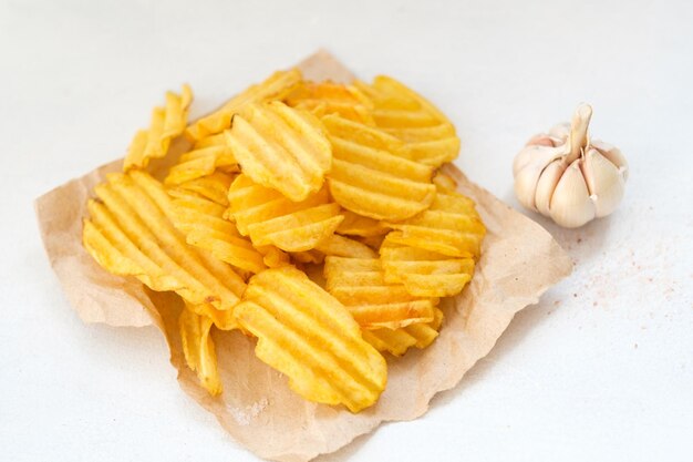 Junk fast food and unhealthy eating crispy chips crunchy potato crisps on white background