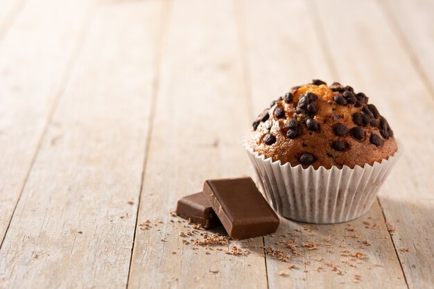 Just baked chocolate muffin on wooden table