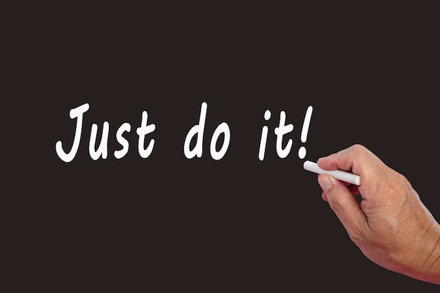 Photo just do it motivational text written on blackboard using chalk