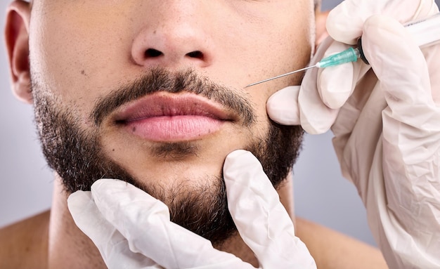 Just a little plummer. Shot of a young man getting injected in his lips.