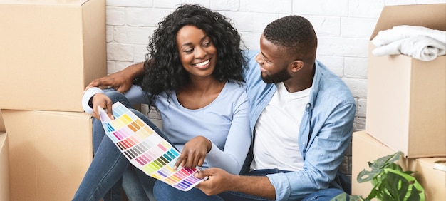 Just married couple choosing walls colour for new apartment