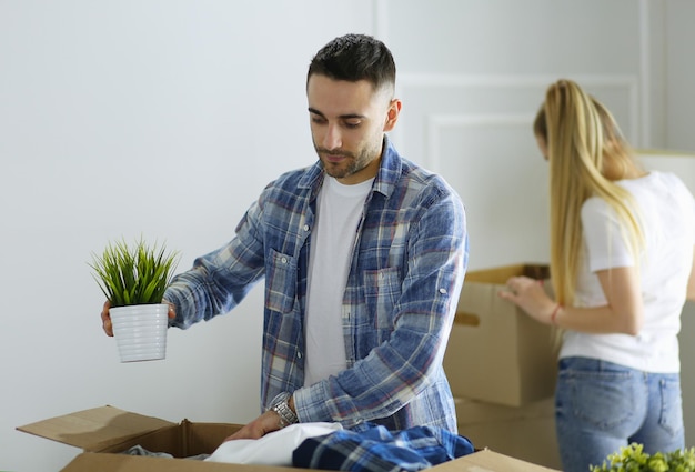 A just married couple unpacking boxes and moving into a new home Positive emotion