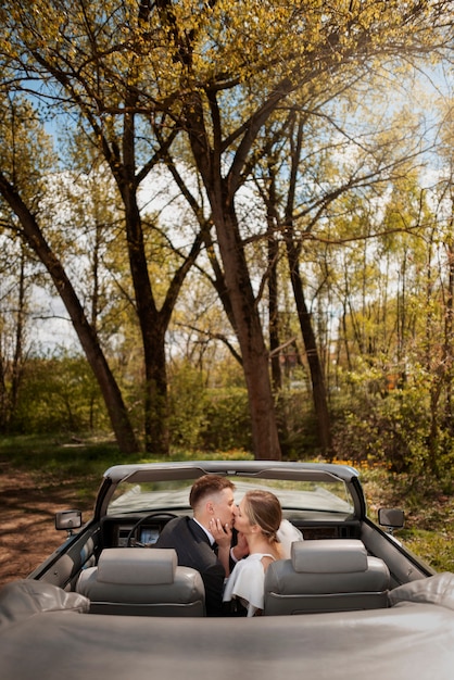 Just married couple with their car