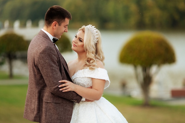 Just married loving couple in wedding dress and suit