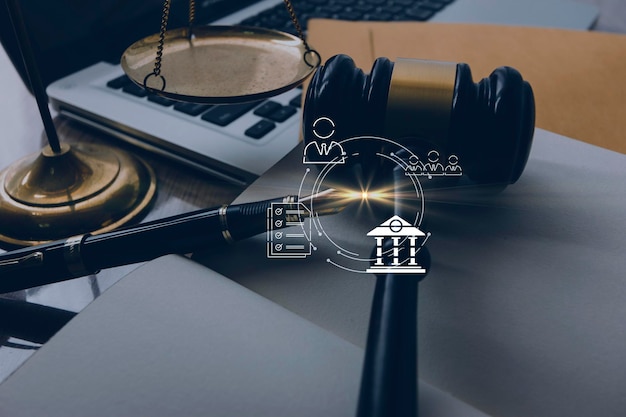 Justice and law conceptMale judge in a courtroom with the gavel working with computer and docking keyboard eyeglasses on table in morning light