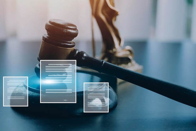 Justice and law conceptMale judge in a courtroom with the gavel working with computer and docking keyboard eyeglasses on table in morning light