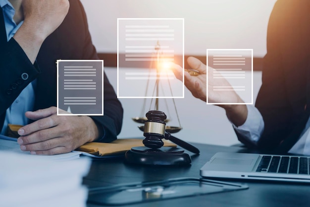 Justice and law conceptMale judge in a courtroom with the gavel working with computer and docking keyboard eyeglasses on table in morning light