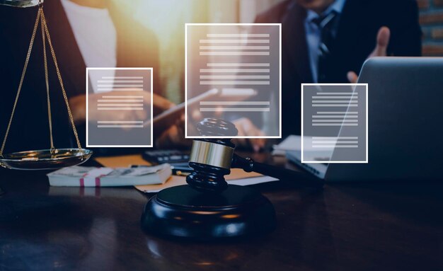 Justice and law conceptMale judge in a courtroom with the gavel working with computer and docking keyboard eyeglasses on table in morning light