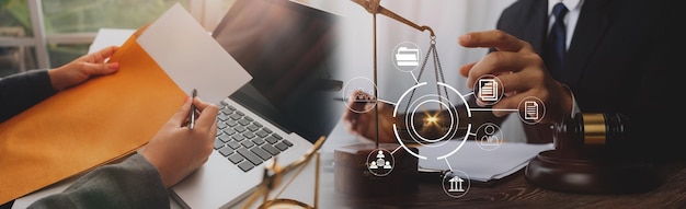 Justice and law conceptMale judge in a courtroom with the gavel working with computer and docking keyboard eyeglasses on table in morning light